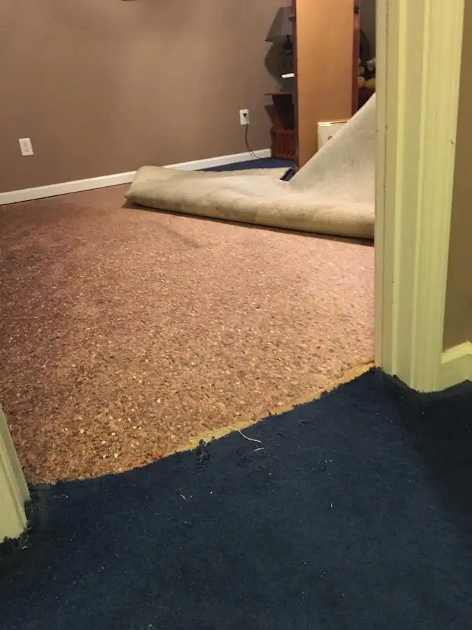 Carpet pad removal revealing water damage during Water Mitigation Services in Tucson Mountains